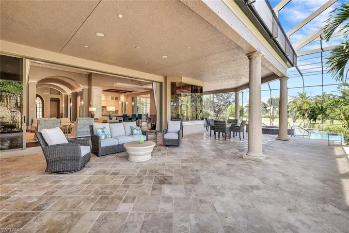 View of patio with outdoor lounge area and glass enclosure