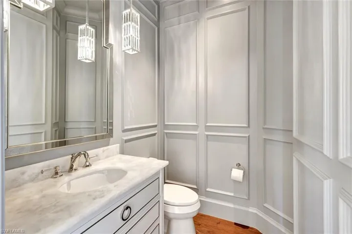 Bathroom featuring hardwood / wood-style floors, vanity, and toilet