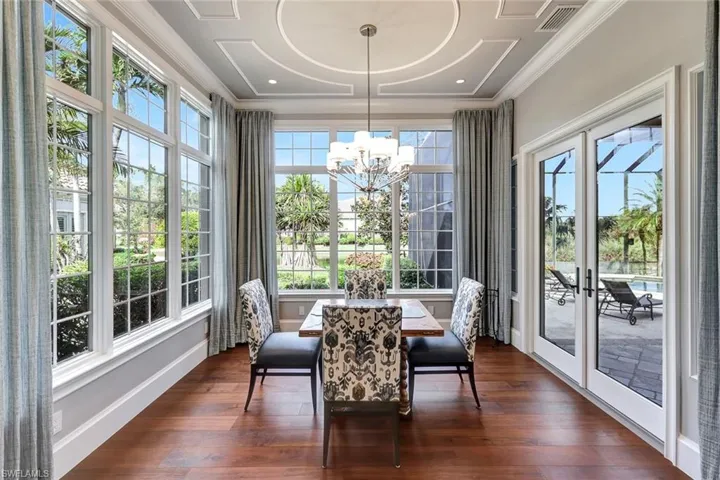 Sunroom / solarium with french doors and a chandelier