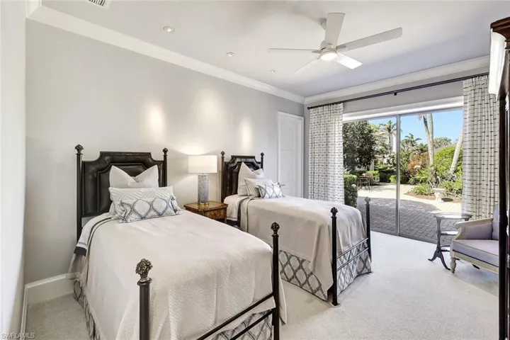 Bedroom with access to exterior, ceiling fan, crown molding, and light carpet