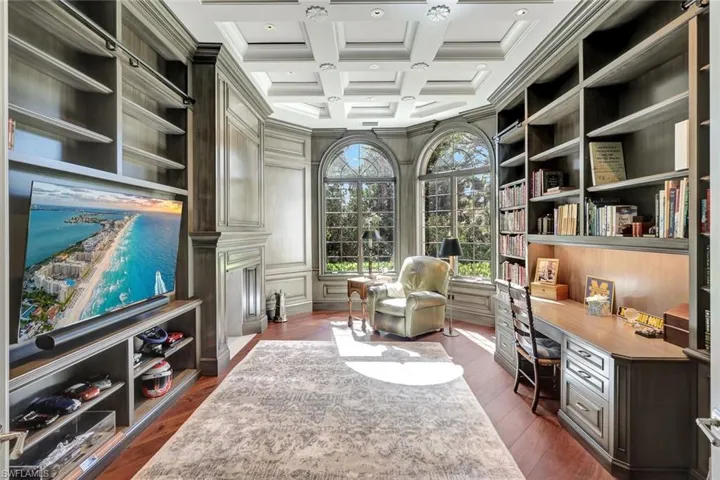 Sitting room with beam ceiling, dark hardwood / wood-style flooring, ornamental molding, and coffered ceiling