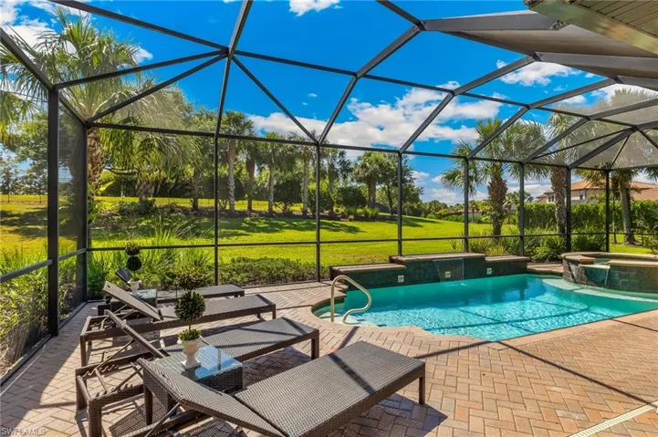 Screened-in outdoor living space with a brick paver patio