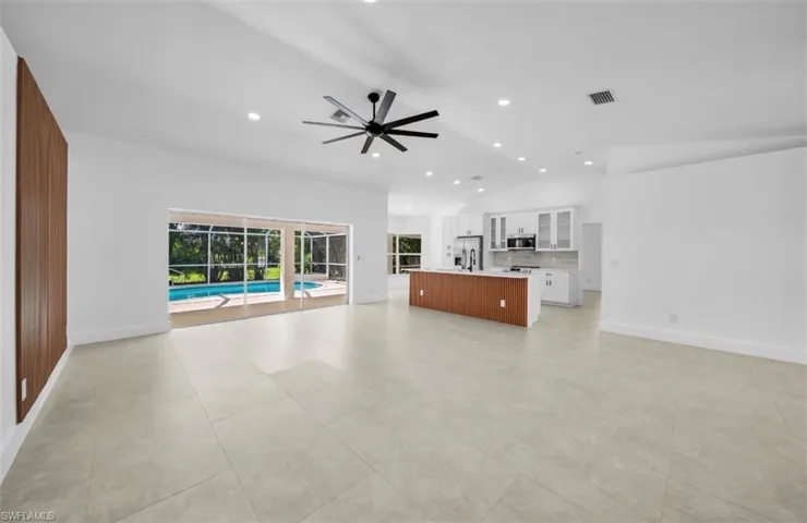 Unfurnished living room with recessed lighting, lofted ceiling, ceiling fan, and light tile patterned flooring