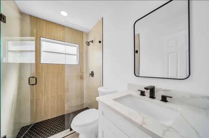 Full bath featuring vanity and a stall shower