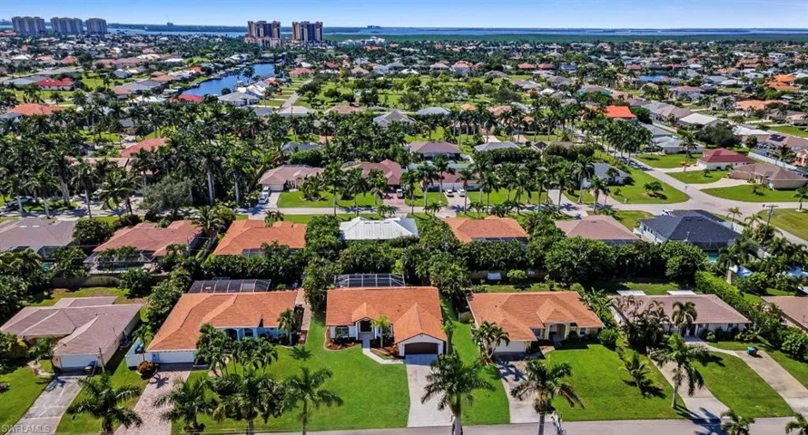 Aerial view of property's location featuring a large body of water