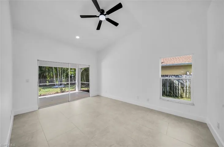 Empty room featuring ceiling fan, high vaulted ceiling, recessed lighting, and light tile patterned floors