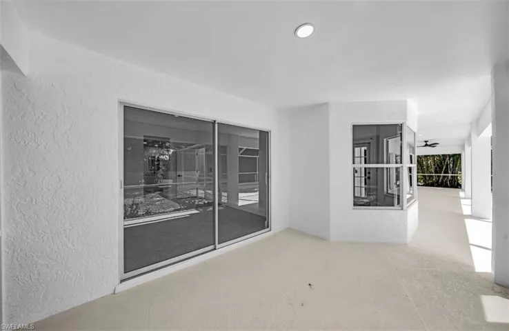 Spare room featuring a textured wall and a sunroom