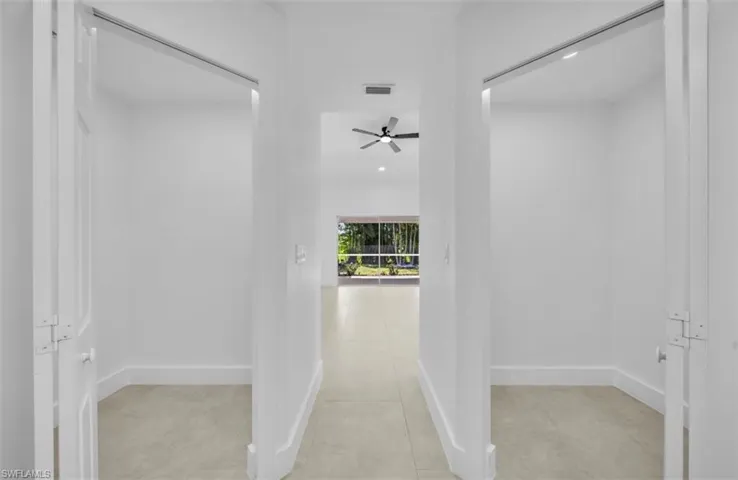 Hallway featuring light tile patterned floors and recessed lighting