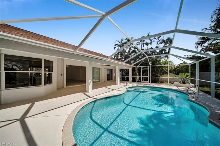 View of swimming pool featuring a sunroom, glass enclosure, a patio area, and ceiling fan