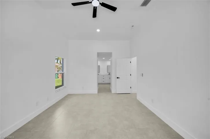 Unfurnished bedroom with recessed lighting, a ceiling fan, ensuite bathroom, and light tile patterned floors