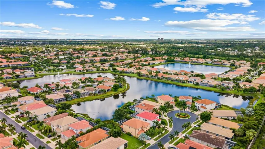 Birds eye view of property with a water view