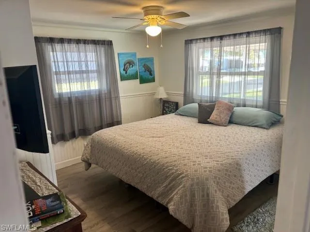 Bedroom featuring ceiling fan and hardwood / wood-style floors