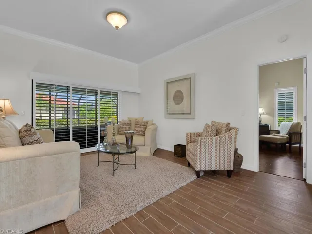 Living room featuring wood finish floors and ornamental molding