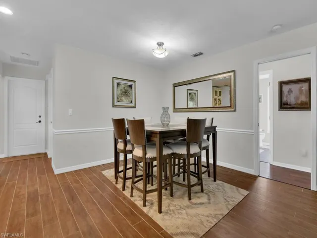 Dining room with a ceiling fan, wood tiled floors, vaulted ceiling, and recessed lighting