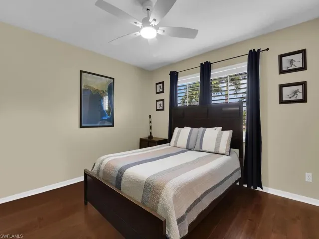 Bedroom featuring wood finished floors and a ceiling fan