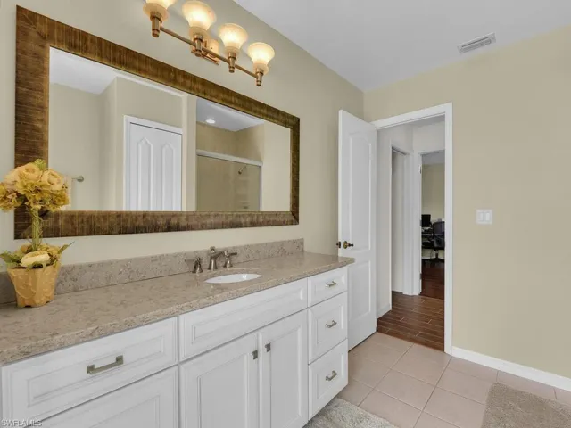 Bathroom featuring vanity, a stall shower, and tile patterned floors