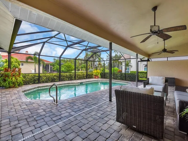 Outdoor pool featuring a lanai, an outdoor living space, a patio area, and ceiling fan