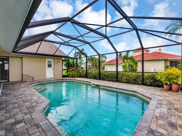 Swimming pool featuring a patio area and glass enclosure