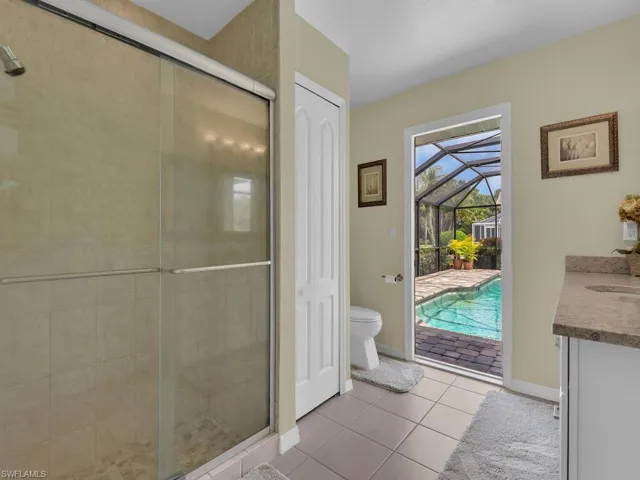 Full bath with tile patterned floors, a stall shower, and vanity
