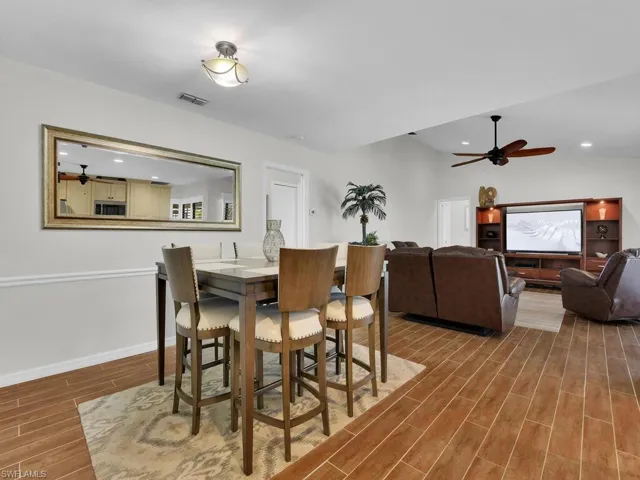 Dining space with wood finish floors, recessed lighting, and a ceiling fan