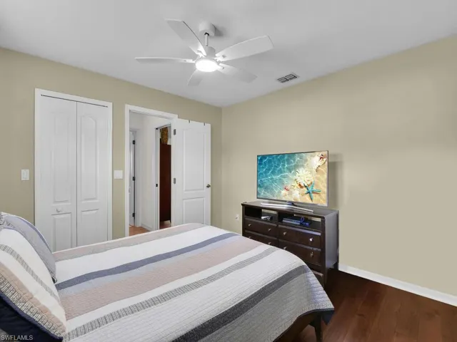 Bedroom featuring wood finished floors, a closet, and ceiling fan