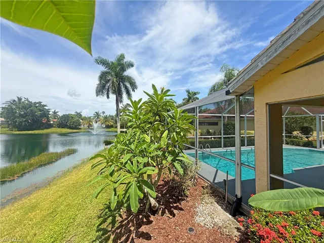 Swimming pool with a sunroom, a lanai, a water view, and a patio