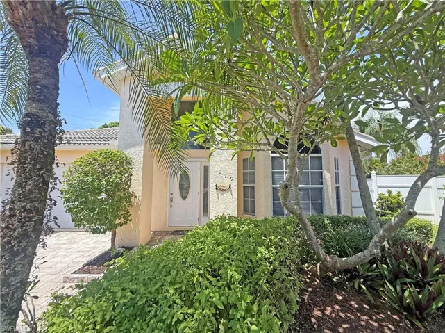 Property entrance with stucco siding and an attached garage