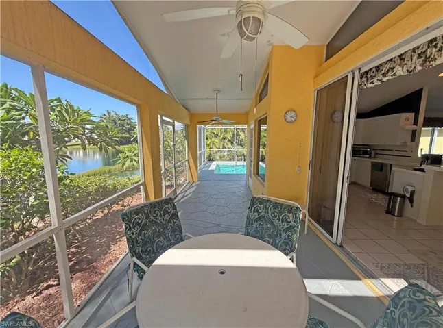 Sunroom featuring vaulted ceiling and a water view