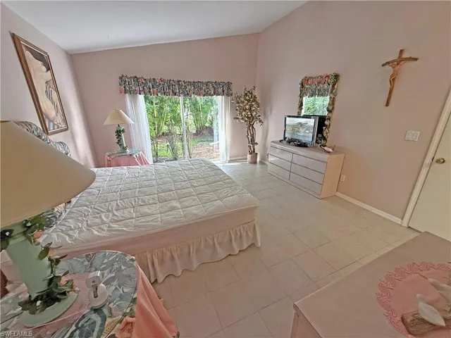 Bedroom featuring vaulted ceiling and light tile patterned flooring