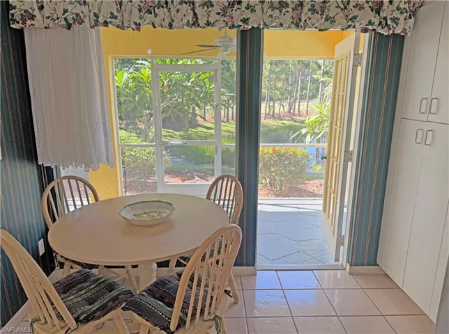 Dining area with light tile patterned floors
