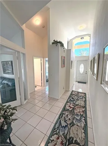 Entryway featuring tile patterned flooring and high vaulted ceiling