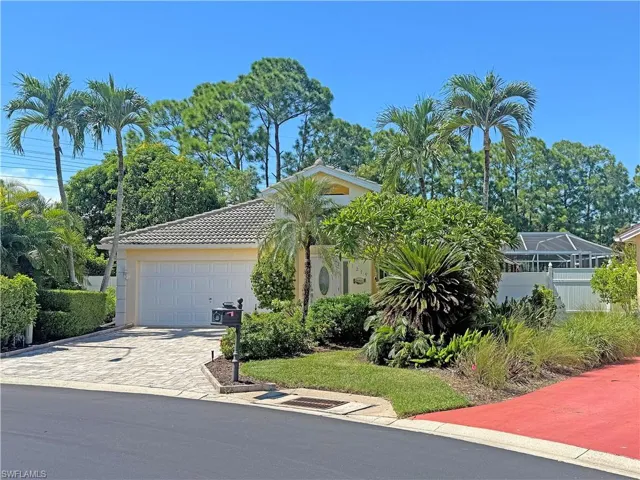 View of front of property with decorative driveway, an attached garage, stucco siding, and a tiled roof