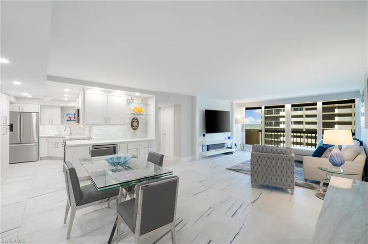 Dining area with light tile patterned floors and sink