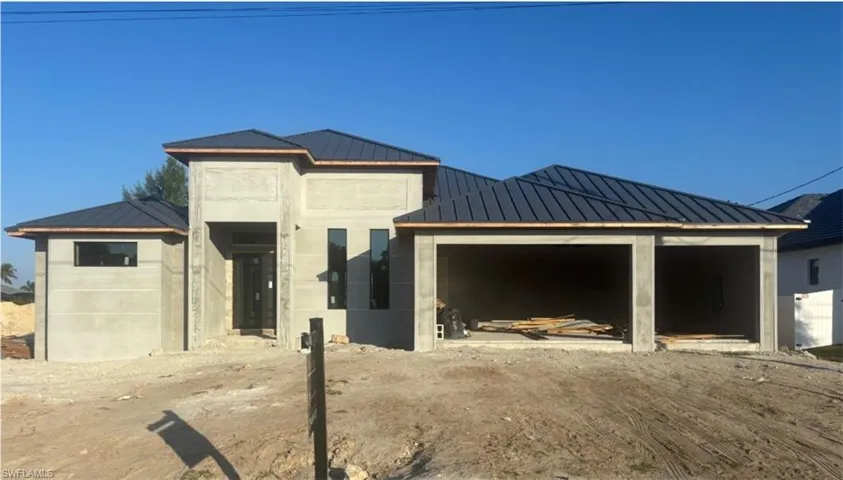 View of front of property with a metal roof, a standing seam roof, and a patio