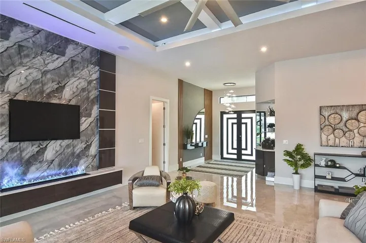 Living room featuring baseboards and recessed lighting
