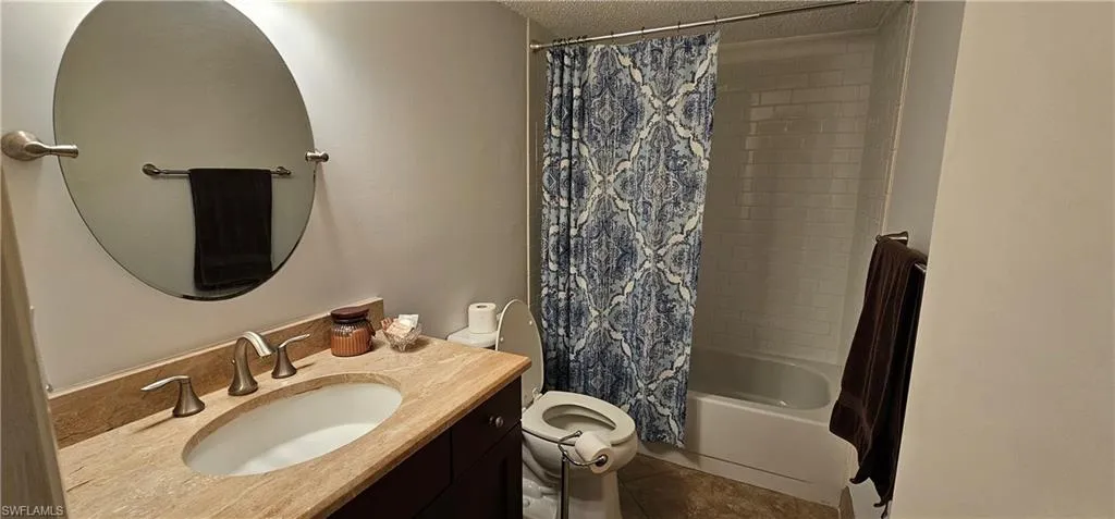 2nd Full bathroom with shower / bath combo, tile patterned floors, a toilet, and vanity