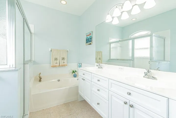 Bathroom with vanity, plus walk in shower, and tile patterned flooring