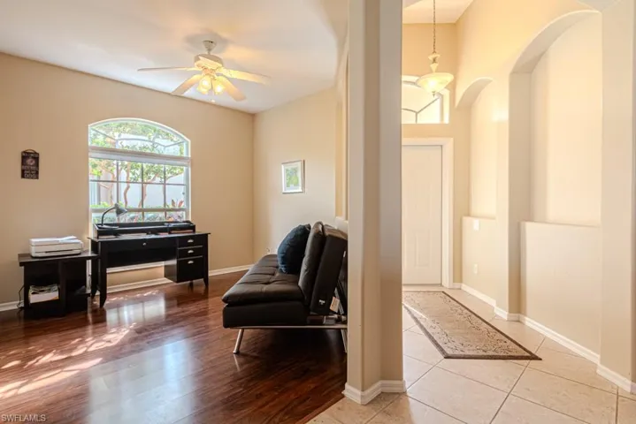 Living area with hardwood / wood-style floors and ceiling fan