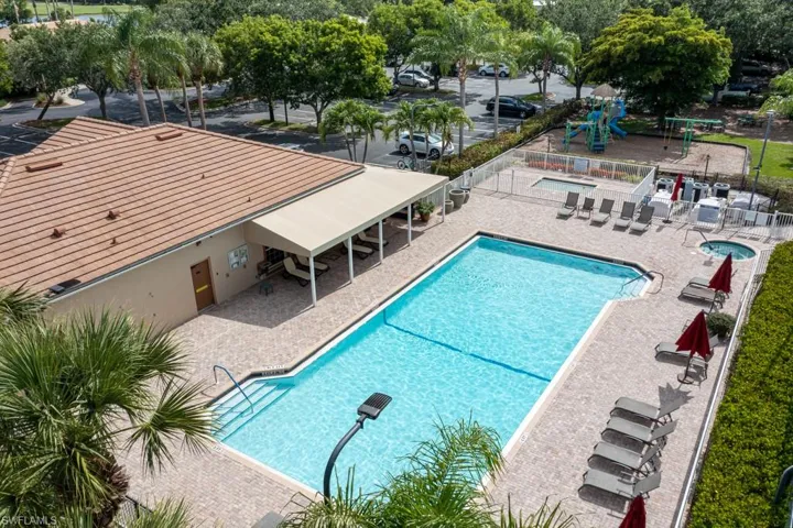 View of swimming pool with a patio and a playground
