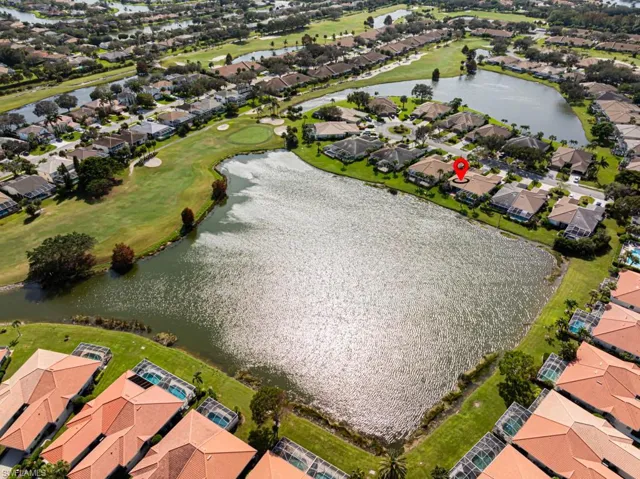 Birds eye view of property with a water view