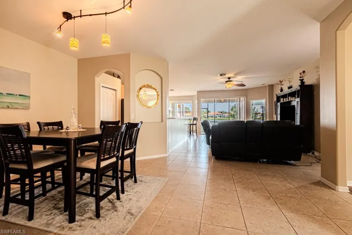Tiled dining space with ceiling fan