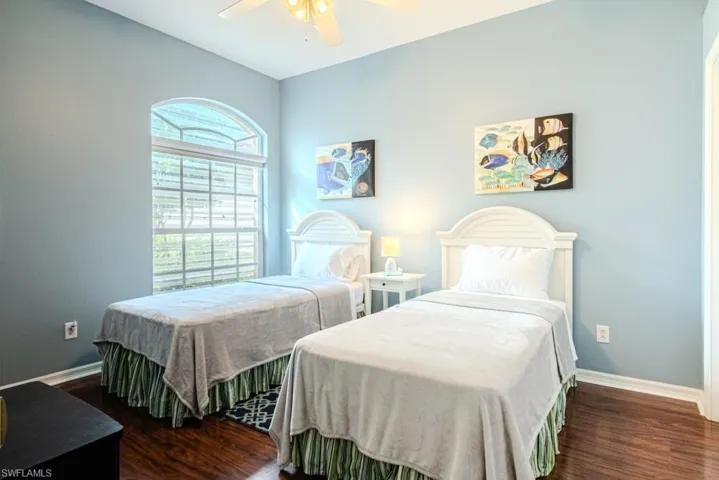 Bedroom featuring dark wood-type flooring and ceiling fan