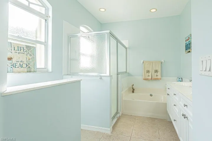 Bathroom with vanity, independent shower and bath, and tile patterned flooring