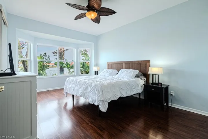 Bedroom with wood-type flooring and ceiling fan