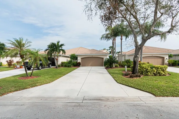 View of front of property with a front lawn and a garage
