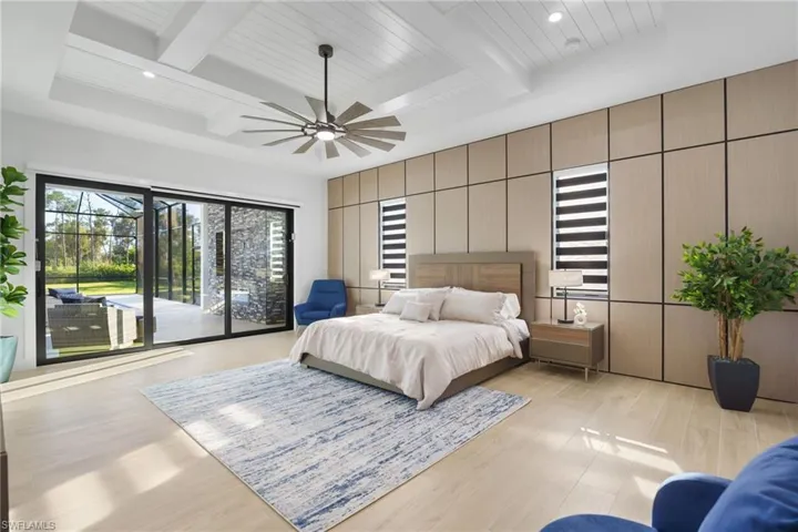 Light and bright primary suite offers direct access to the pool deck