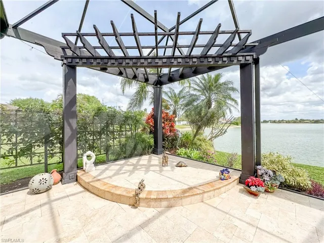 View of patio / terrace with a pergola and a water view