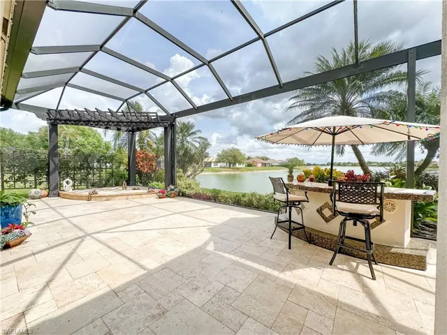 View of patio with a water view, a lanai, and a sunroom