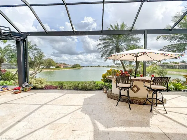 View of patio featuring a water view and a sunroom