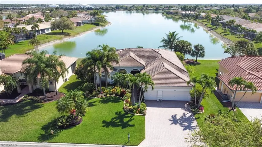 Aerial perspective of suburban area featuring a nearby body of water